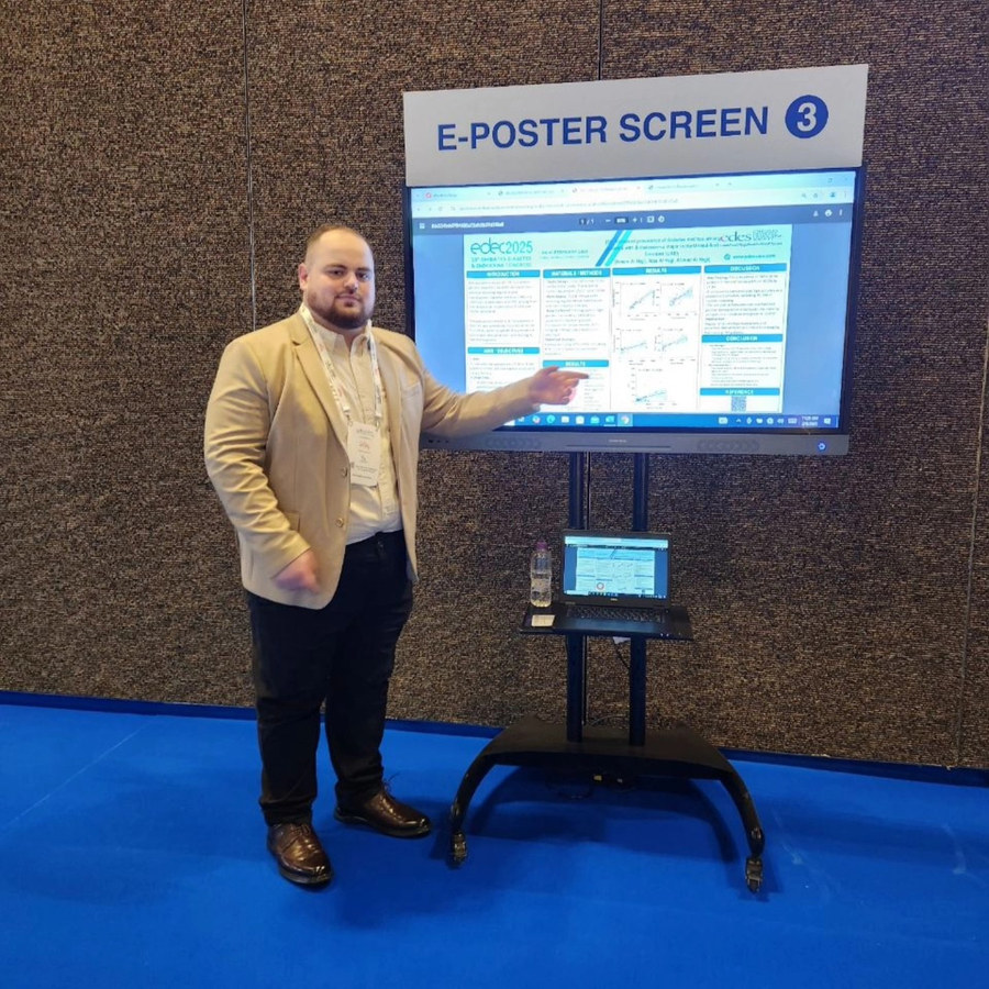 Ahmad presenting his e-poster at EDEC 2025