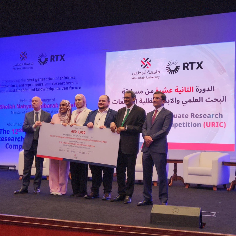 Ahmad and his team on stage receiving the second place cheque at URIC